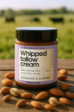 Southern Glow Pistachio and Almond Whipped Tallow Cream sitting next to pistachio nuts on a wooden table.
